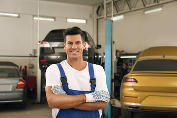 Portrait of professional mechanic at automobile repair shop