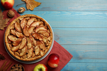Delicious apple pie and ingredients on turquoise wooden table, flat lay. Space for text