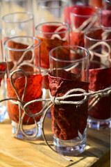 cup decorated with red leaf and rope bow
