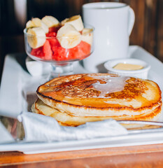 Omelet breakfast with fruit salad served on a wooden table, healthy breakfast concept with COPY SPACE