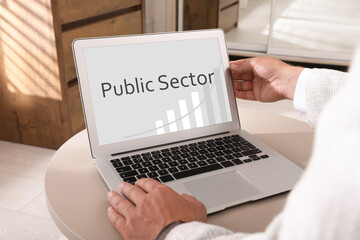 Public Sector. Man working with modern laptop at table, closeup