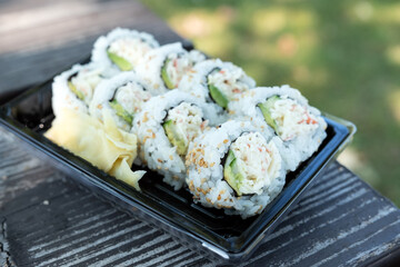 california rolls maki sushi japanese food on picnic table outdoor © Kenishirotie