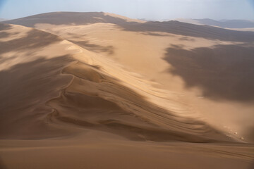 Fototapeta na wymiar Nature and landscapes of dasht e lut or sahara desert with sand dunes and cloudy evening sky