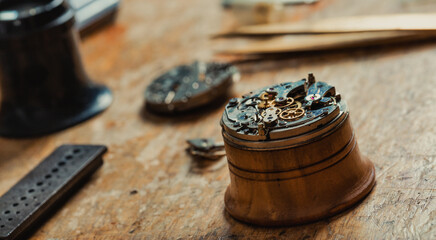 Watch mechanism mounted on a stand for repairs