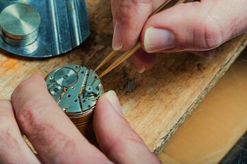 Watchmaker repairing the mechanism of an old watch