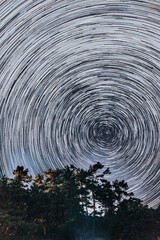 Astrophotography of startrail over tree top near Fukuoka, Japan. Star trail photo near Fukuoka Japan. 