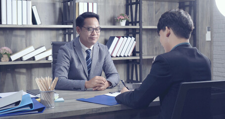 Job HR applicants having an interview with Human resource manager jobs interviewing with confident candidate at business firm office give cv resume. Job Interview with headhunter agent and applicant