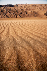 the formation of sands in dasht e lut or sahara desert with waved sand pattern on sand dune. Nature and landscapes of desert. Middle East desert