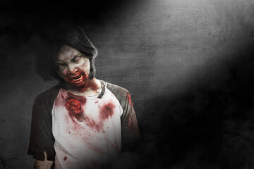 Scary zombie with blood and wound on his body standing