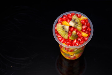 Mixed cut fruits arranged in a transparent tableware , isolated.
