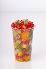 Mixed cut fruits arranged in a transparent tableware , isolated.