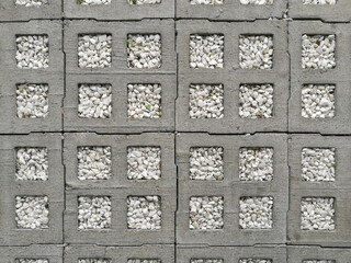 Square brick floor tile with gravel texture.