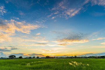 Twilight blue bright and orange yellow dramatic sunset sky in countryside or beach colorful cloudscape texture with white clouds air background.