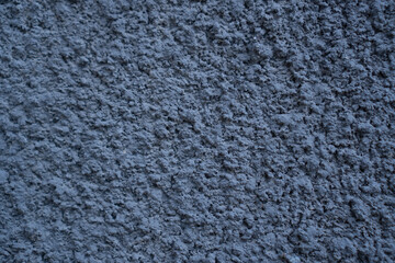 Black external textured plaster. Structure of black cement plaster. Building facade background. Stucco wall