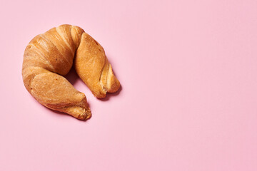 Moon shaped traditional french croissant on isolated background with copy space. Horizontal photo. Top view angle. Food and healthy concepts.