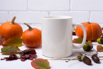 White coffee mug mockup with pumpkins, acorns