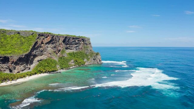 Beautiful Caribbean landscape. Volcanic peninsula in a bright blue sea landscape. Aerial view of a tropical island in the ocean.