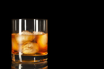 Bourbon glass on the black background, copy space