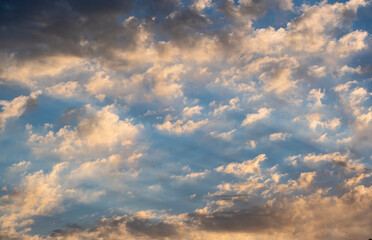Blue sky with clouds at sunrise. Morning sky background