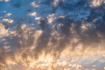 Blue sky with clouds at sunrise. Morning sky background