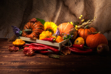 Fall centerpiece with pumpkin, red peppers and burlap