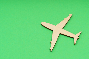 Fototapeta na wymiar The wooden airplane flies up. Isolated on a green background.