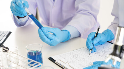 Team of Medical Research Scientists or researcher in lab coat testing their experimental in Modern...