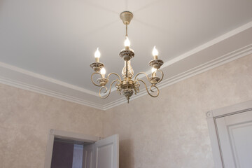 modern lamps in a large house. Chandeliers of an interesting configuration with bends and contours