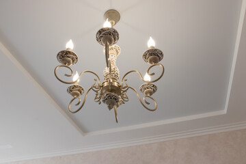 beautiful chandelier with bulges and contours in a large house, modern lamps