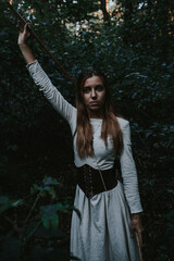 Fototapeta na wymiar girl in a historical dress in a coniferous forest