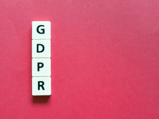 Word GDPR made from square letters against red background. General Data Protection Regulation.
