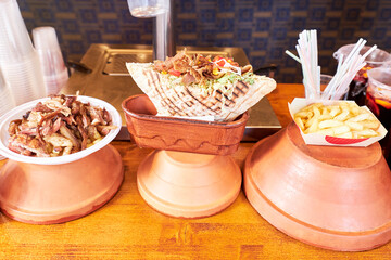Kebab and fries on a bar counter for sale. Food concept
