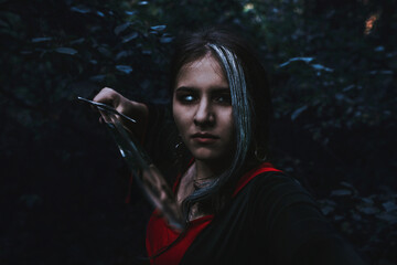 Fototapeta na wymiar girl in a historical dress in a coniferous forest