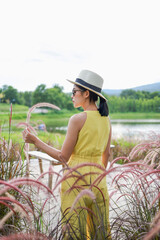 Summer Beautiful young woman fabulous nature waiting for summer sun on meadow vacation Asian girl Happy girl relaxing enjoys the autumn sunset