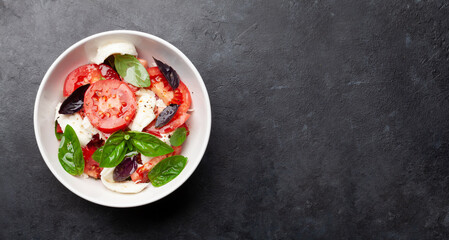Caprese salad with fresh tomatoes, basil and mozzarella cheese