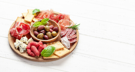 Obraz na płótnie Canvas Antipasto board with prosciutto, salami, crackers, cheese, olives