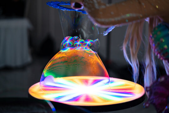 show of soap bubbles with multi-colored lighting and smoke at the holiday.