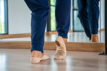  Confidence Caucasian male ballet dancer practicing ballet dance alone in studio room. Handsome man athletic dancing classic ballet showing performance body stretching and strength muscle.