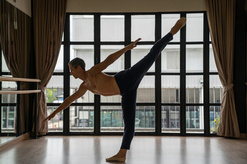  Confidence Caucasian male ballet dancer practicing ballet dance alone in studio room. Handsome man athletic dancing classic ballet showing performance body stretching and strength muscle.