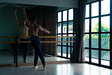  Confidence Caucasian male ballet dancer practicing ballet dance alone in studio room. Handsome man athletic dancing classic ballet showing performance body stretching and strength muscle.