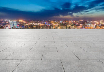 empty brick floor with city skyline background