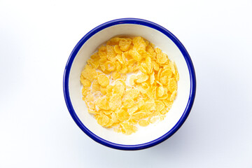 Breakfast cereals. With milk. In a plate. Isolated on white.