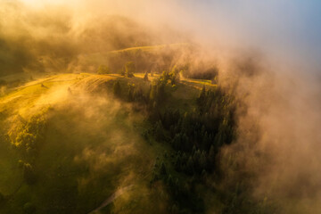 Aerial view of foggy sunrise in the mountains. Carpathian mountains.