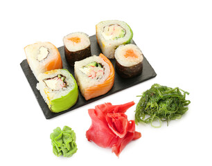 Board with delicious sushi rolls, ginger, chukka and wasabi on white background