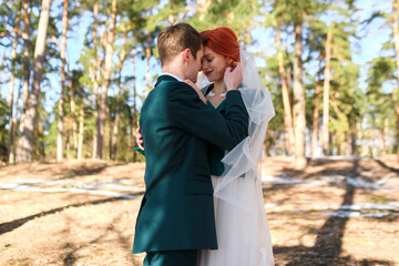 wedding day, husband and wife are in love with each other. young couple in love outdoors in the forest
