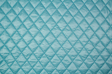 Quilted fabric. The texture of the blanket. Blue textiles	
