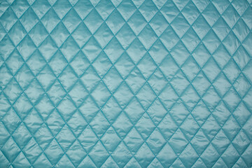 Quilted fabric. The texture of the blanket. Blue textiles	
