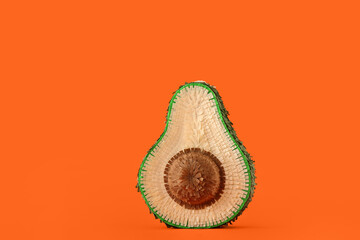 Mexican pinata in shape of avocado on orange background