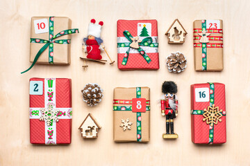 Handmade wrapped red, green gift boxes decorated with ribbons, snowflakes and numbers, Christmas...