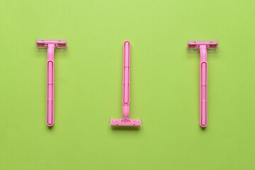 Safety razors on green background